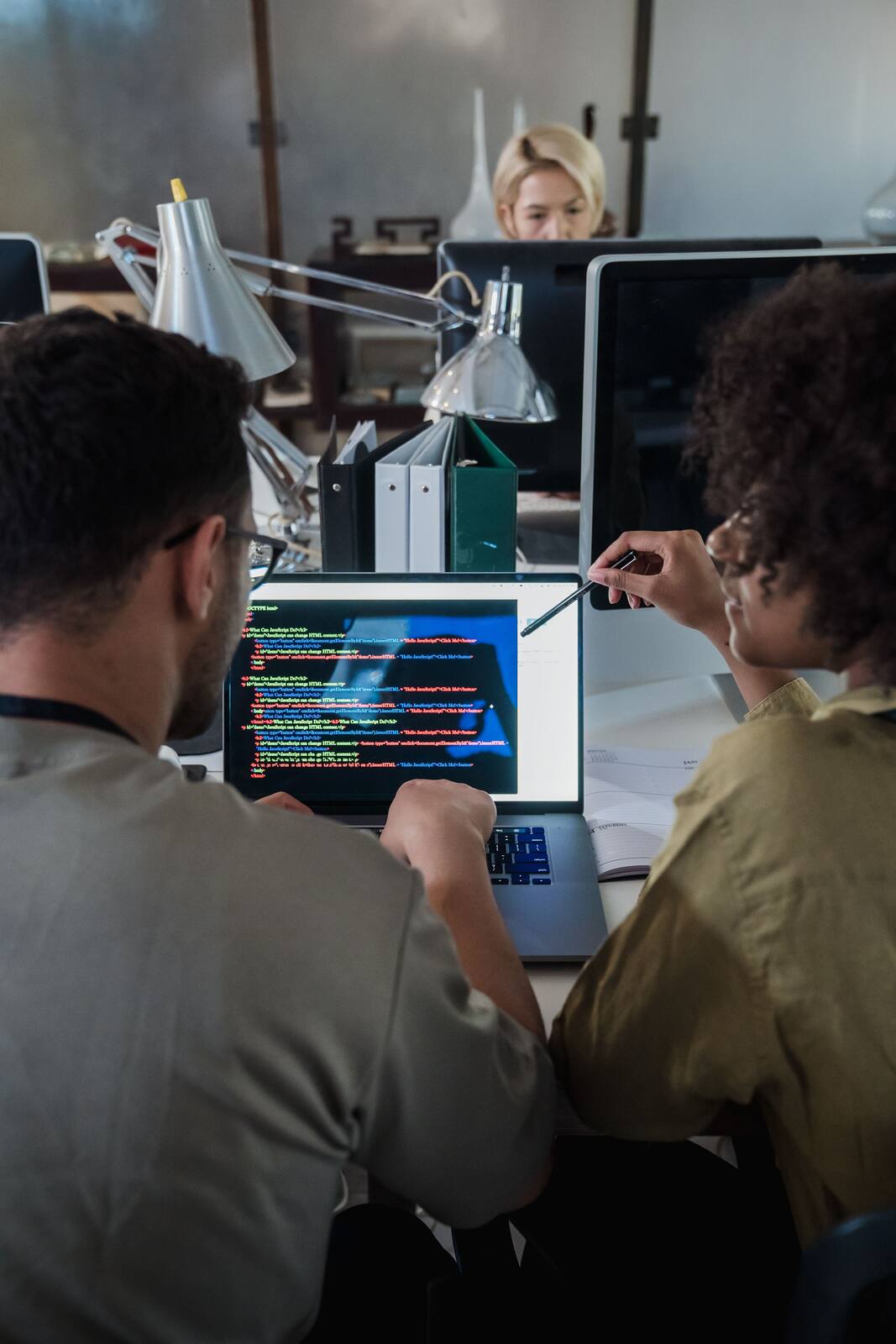 Team discussing software development and AI opportunities on a laptop